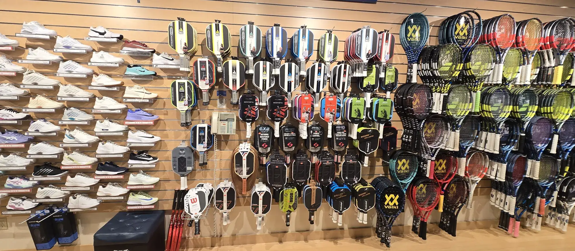 The paddle wall at the Mequon shop, with court shoes on the left.
