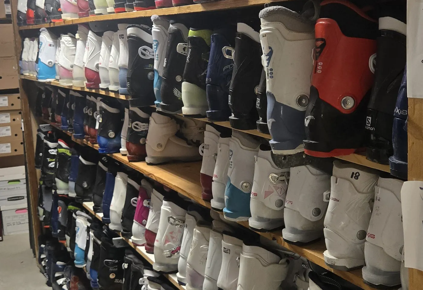 The rental boot fleet racked downstairs at the Mequon shop.
