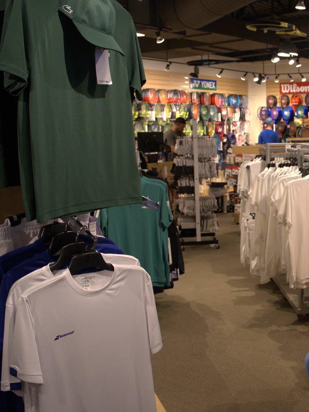 Men's tennis polos and performance tees at the Mequon shop.