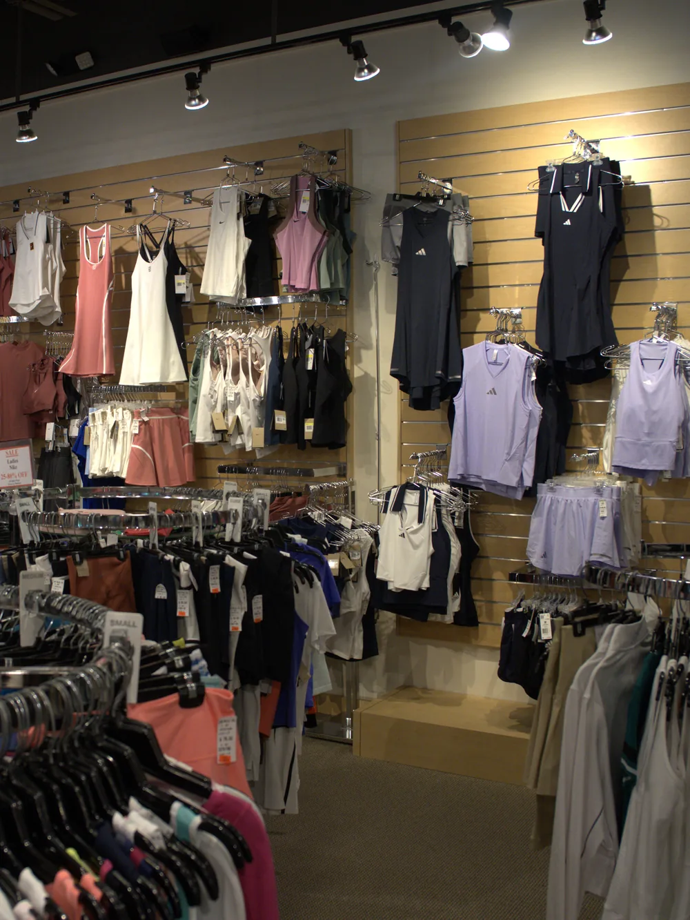 The women's tennis apparel section at the Mequon shop — dresses, tanks, tops and skirts.