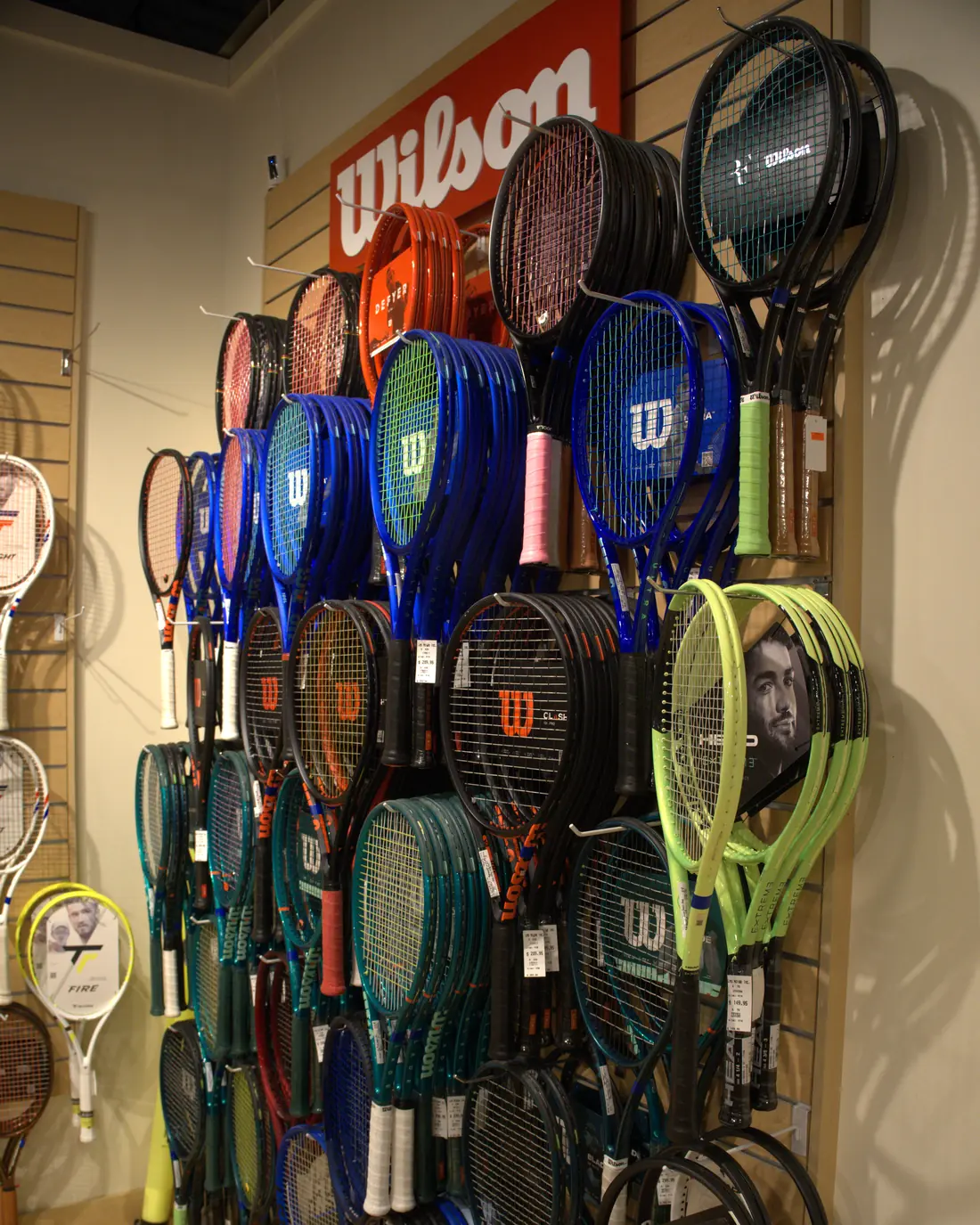 Tennis racquets stacked on the Wilson wall at the Mequon shop.